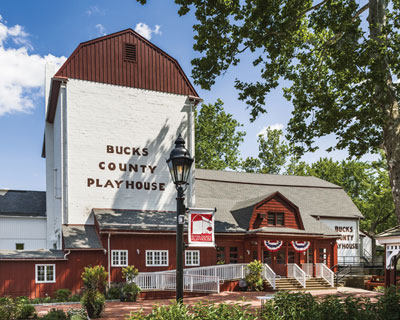 Exterior of Bucks County Playhouse, a red, white, and brown building.