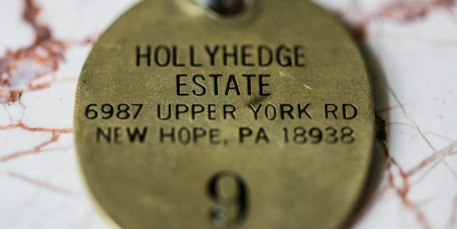 Bronzed room tag with "HollyHedge Estate," its address, and room number imprinted.